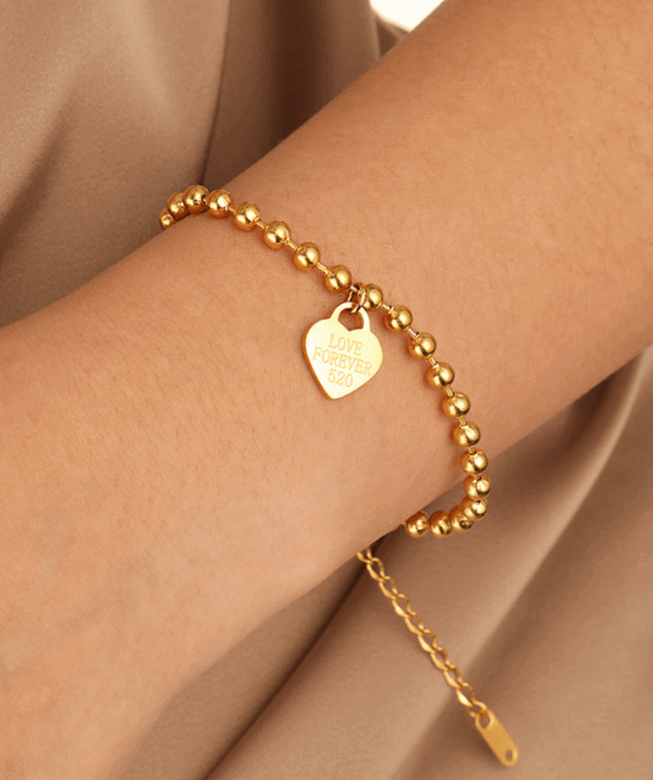 81769f32c9949b949da49d8114991d6 Titanium Steel Bead Bracelet with Engraved Heart Charm – Adjustable Chain