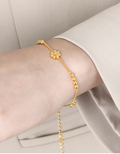 cc1aae87375af17223be7c1a97999ad Triple Daisy Chain Bracelet – Gold Titanium Steel with Floral Accents