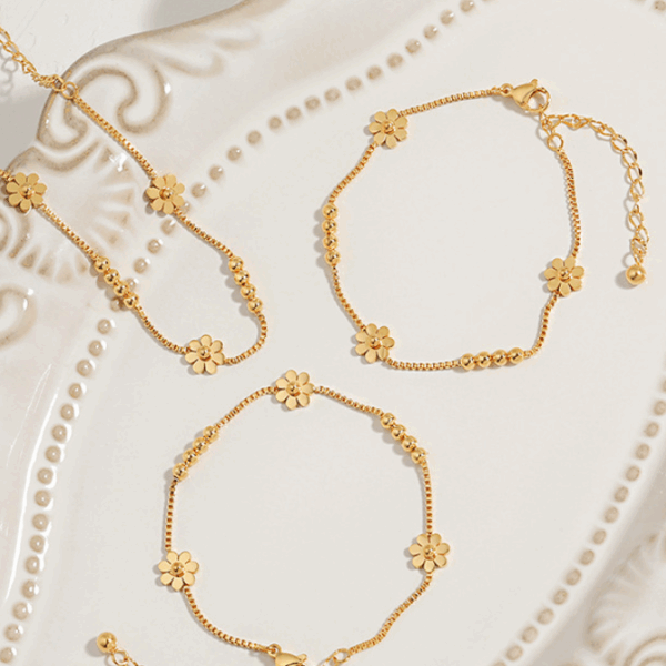Triple Daisy Chain Bracelet – Gold Titanium Steel with Floral Accents
